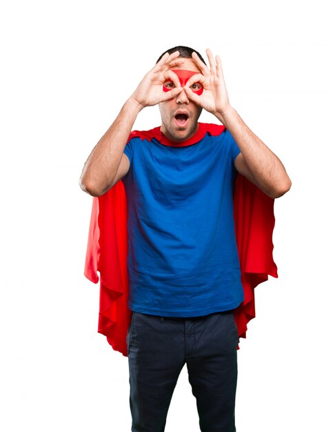 Surprised superhero with observe gesture