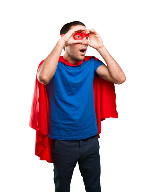 Surprised superhero with observe gesture