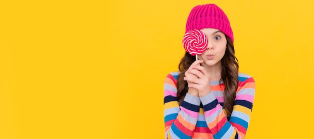 Surprised teen girl hold lollipop lollipop lady hipster kid with colorful lollypop sugar candy Teenager child with sweets poster banner header copy space