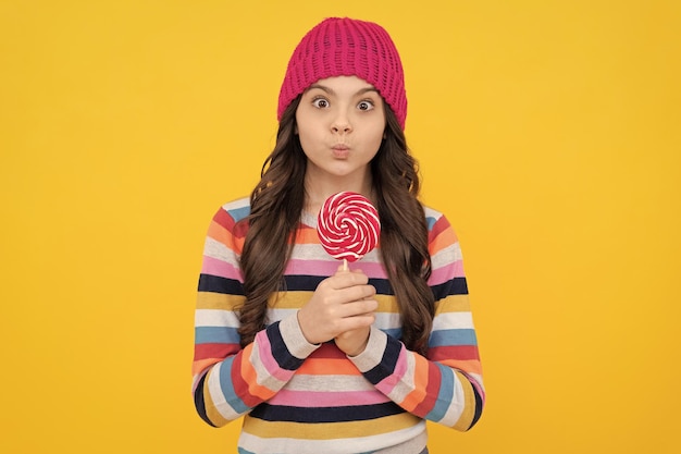 Surprised teen girl with lollipop candy childhood