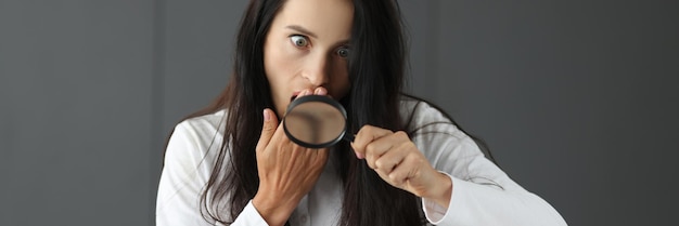 Photo surprised woman looking through magnifying glass and covering mouth with hand page not found