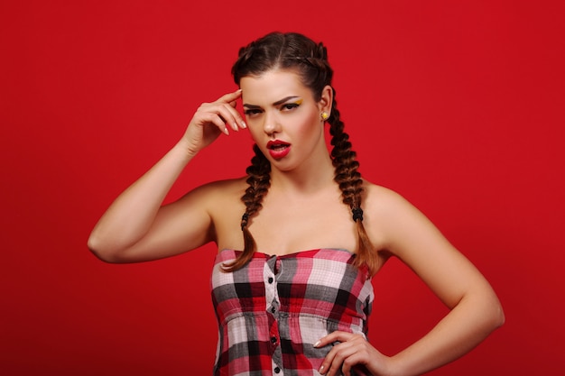 Surprised woman with mouth open. Makeup. Beauty woman with red wall. Open mouth Emotions