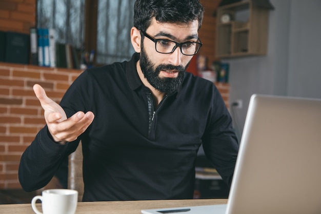 Surprised working man in the office table