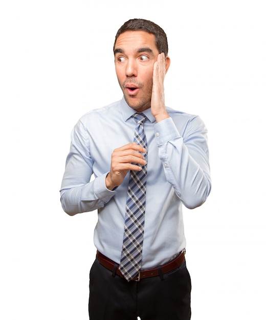 Surprised young businessman posing