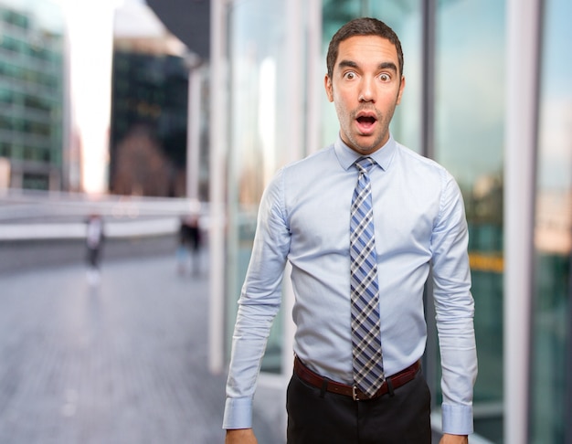 Surprised young businessman posing