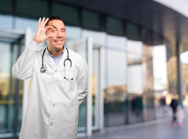 Surprised young doctor doing an observe gesture