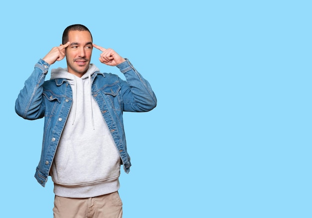 Surprised young man doing a gesture of concentration