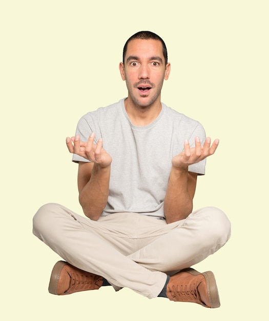 Surprised young man making a gesture of doubt