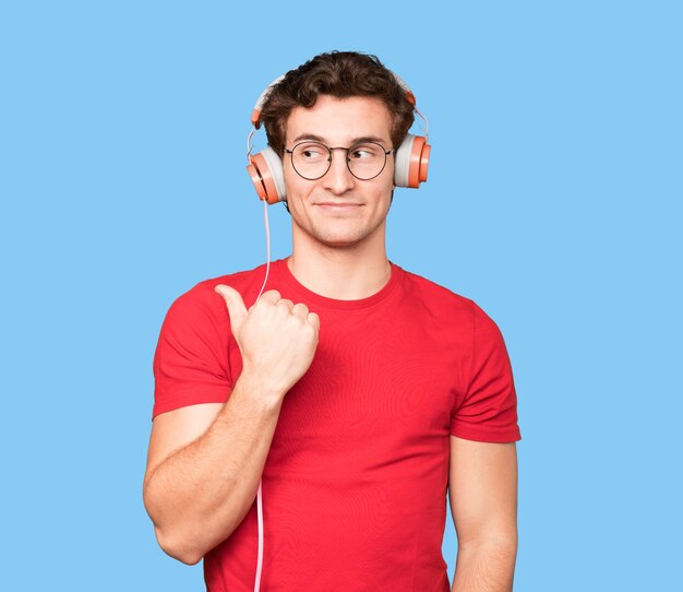 Surprised young man using a smartphone and pointing with his finger