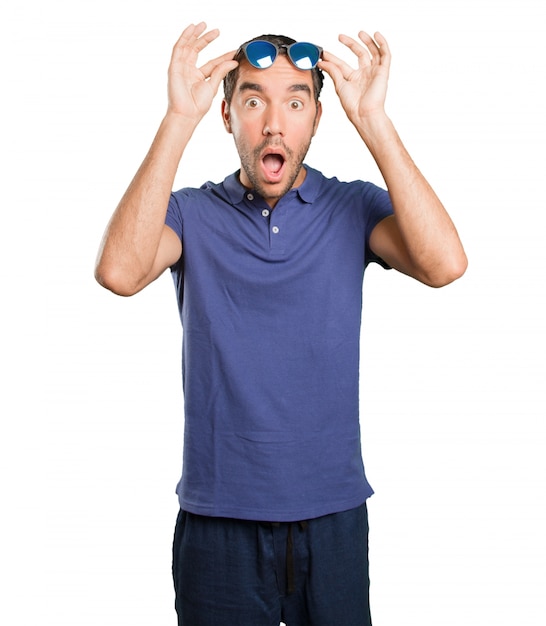 Surprised young man on white background