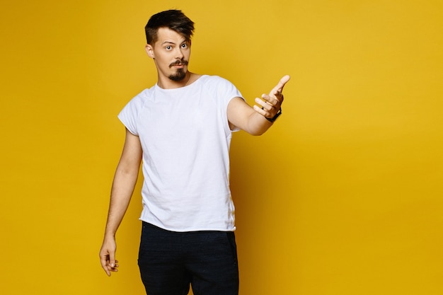 Surprised young man with mustache and beard in white blank t-shirt