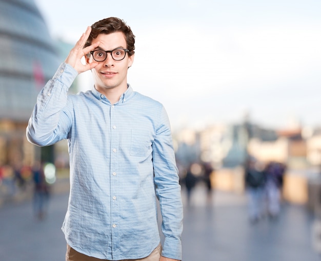 Surprised young man with an observe gesture