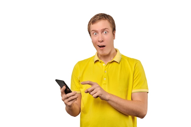 Surprised young man with smartphone funny guy holding phone isolated on white background