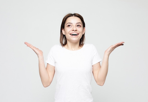 Surprised young woman looking sideways in excitement