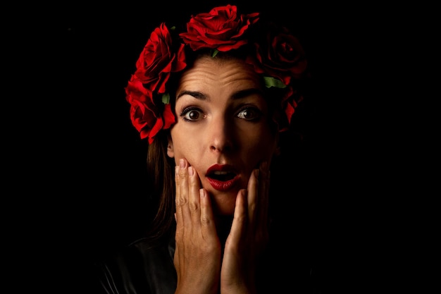 Surprised young woman in a wreath of flowers