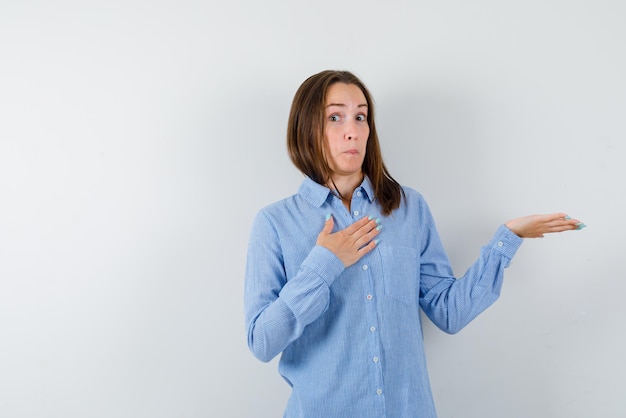 Surprising young girl showing the right with hands on white background