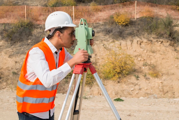 Surveyor engineer worker making measuring with theodolite instrument equipment