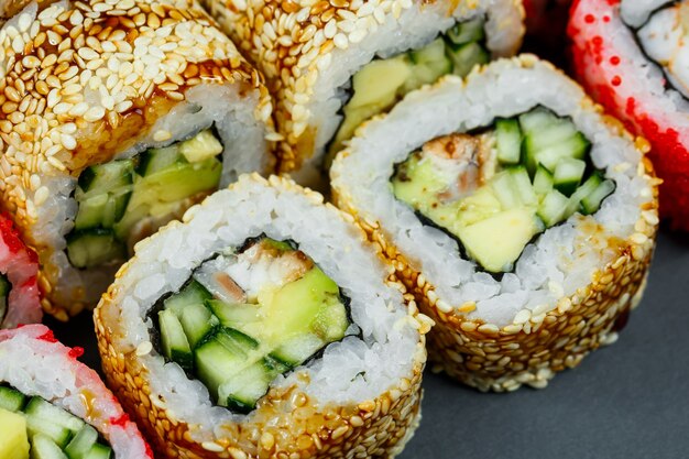 Sushi assorted. Sushi roll with avocado, cucumber. Sushi roll with salmon and caviar. Sushi roll with tuna and caviar. On a light background. Japanese food. View from above