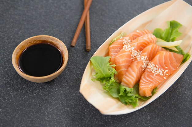 Sushi on boat shaped plate with chopsticks