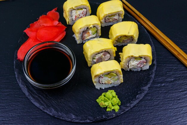 Sushi cheese rolls on a black slate