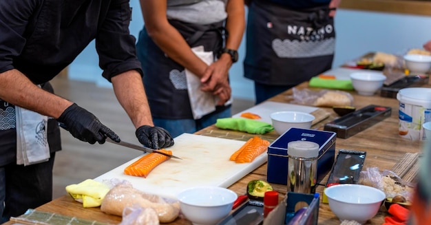 Sushi cooking workshop Master sushi chef cutting a salmon loin