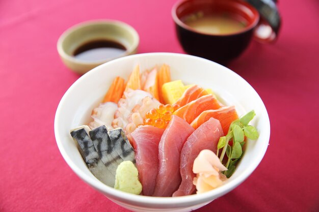 Sushi don , raw salmon tuna octopus on rice