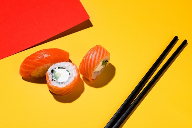 Sushi en broodjes op een gekleurde achtergrond, sojasaus, gember. Met een hard licht