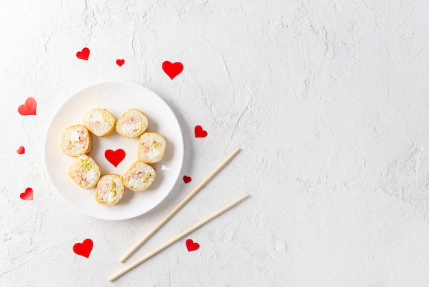 Sushi in the form of a heart on a white plate, valentine's day.