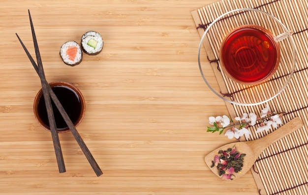 Sushi maki set herbal tea and sakura branch