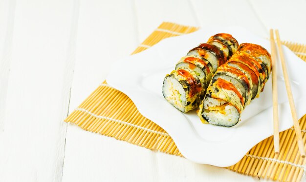 sushi on modern white dish and sticks