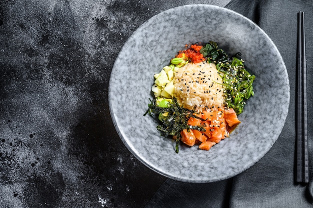 Sushi poke bowl with cucumber, salmon, avocado