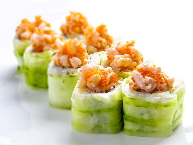 Sushi roll avocado shrimp and tobiko on the white background