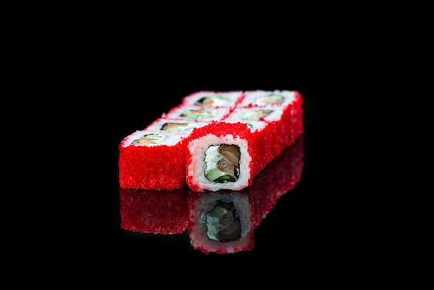 Sushi roll on a black background reflection  japanese food close up