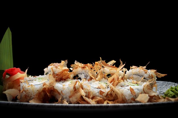 Sushi roll Bonito with eel and tuna on a dark background