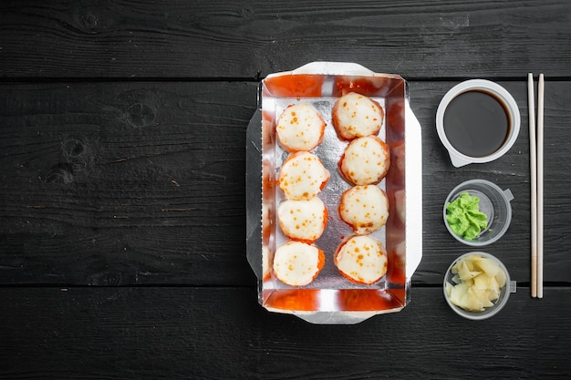 Sushi roll delivery set, on black wooden table