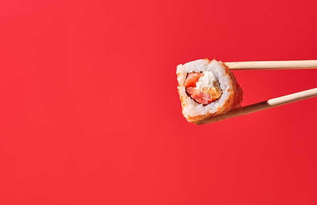 Sushi roll on red background