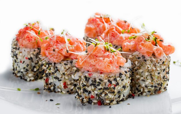 Sushi roll in sesame with smoked salmon and alfalfa