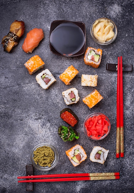 Sushi and roll set on black table