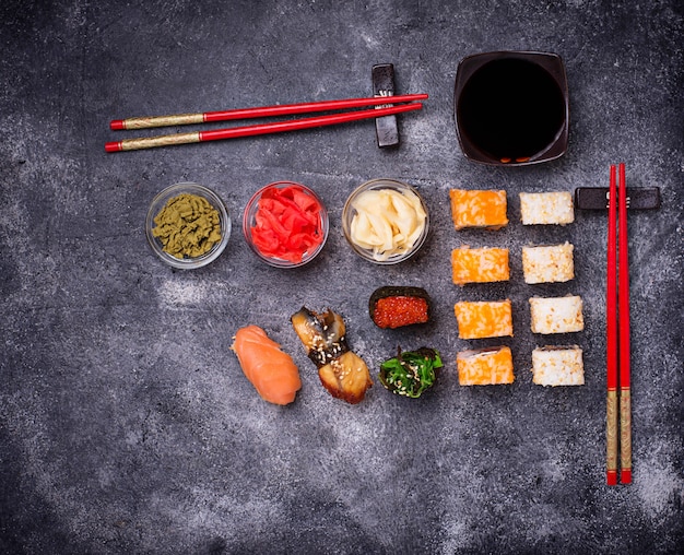 Sushi and roll set on black table