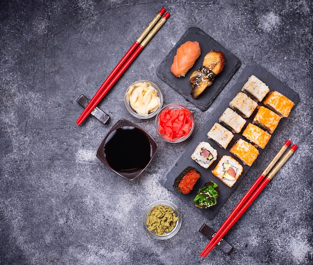 Sushi and roll set on black table