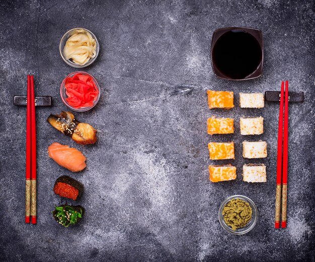 Sushi and roll set on black table