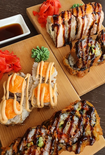 Sushi roll set on wooden plates in the restaurant top view flat lay