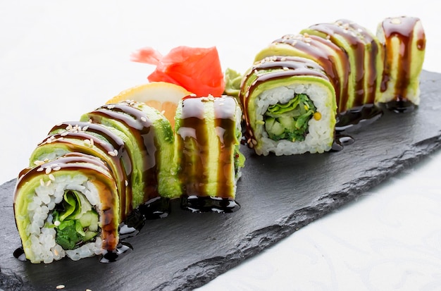 Sushi roll with avocado cucumber salad and seaweed Vegetarian dish On white background