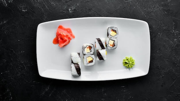 Sushi roll with fish free space for your text Top view On a stone background