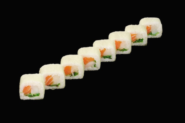 Photo sushi roll with salmon, scallop, chuka, soy paper, unagi sauce isolated on black