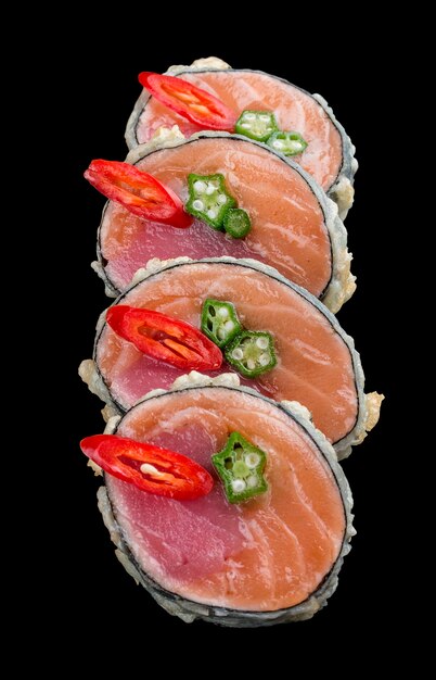 Sushi roll with salmon and tuna on black background