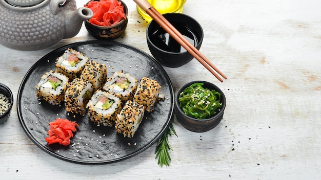 Sushi roll with sesame Philadelphia cheese salmon avocado Japanese Traditional Cuisine Top view Rustic style