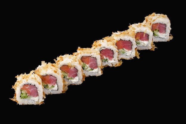 sushi roll with tuna, cold smoked salmon, feta cheese, cucumber, tuna flakes isolated on black