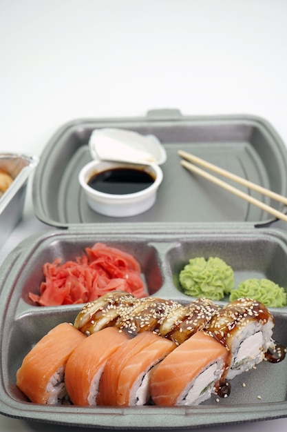 Sushi rolls are Packed in plastic packaging close-up on an isolated wall