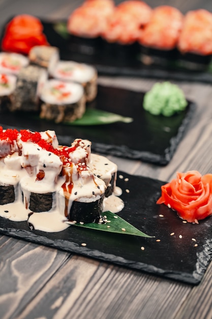 Sushi rolls on a black background